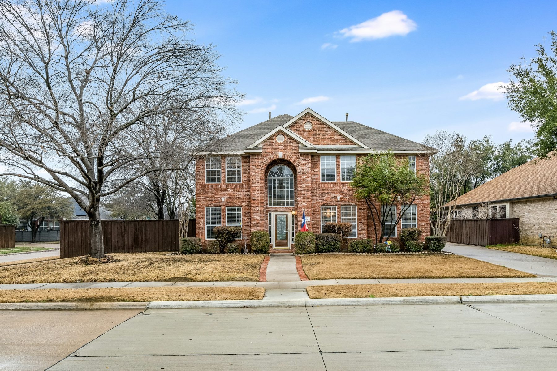 Two-story brick home in a North Texas neighborhood